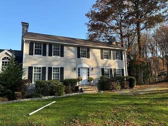 Completed brown asphalt shingle roof on a colonial home in Fairfield County, Connecticut