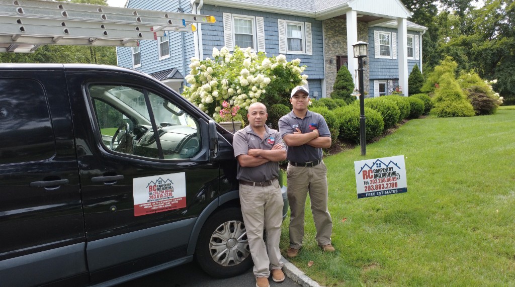 Rudy and Josue Chinchilla with the RC Carpentry & Roofing company van at a Fairfield County home