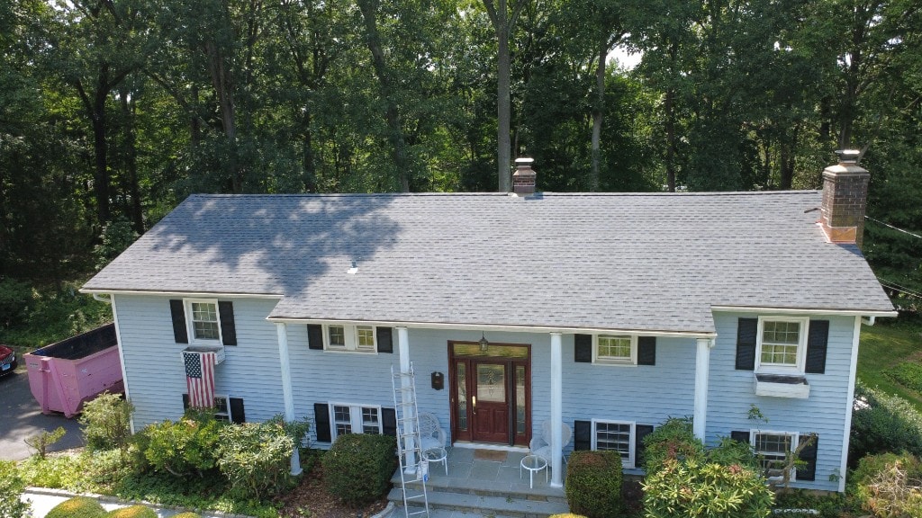 After — completed dark grey shingle roof on a blue colonial home in Fairfield County